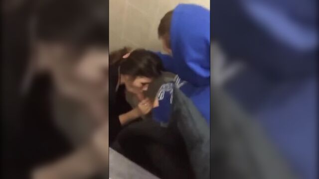 CUTE YOUNG BRUNETTE GETS CAUGHT GIVING HEAD IN A PUBLIC BATHROOM