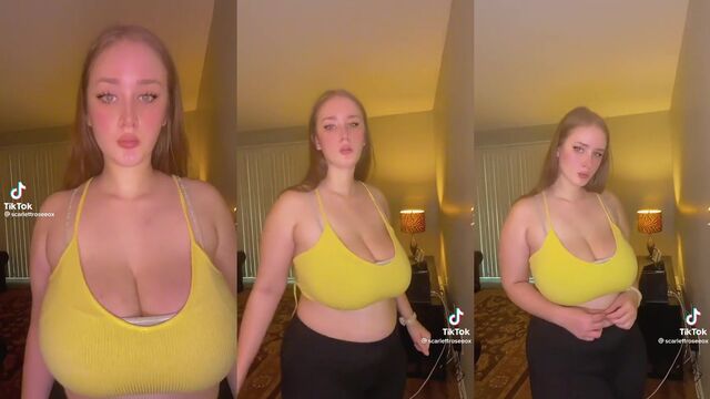Busty babe shows off her huge natural tits while stripping