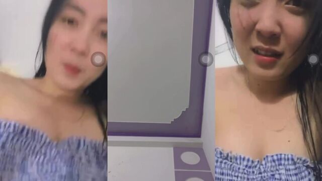 A hot Vietnamese girl helps herself in the bathroom, creating a steamy scene