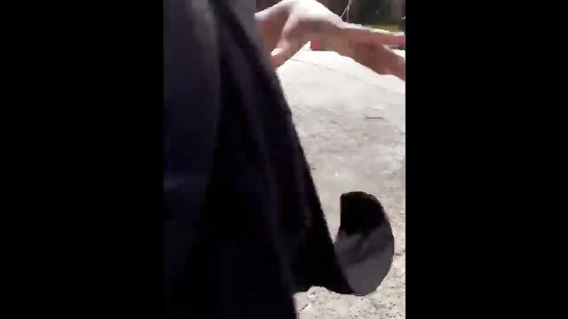 A girl is masturbating publicly in a risky spot outdoors