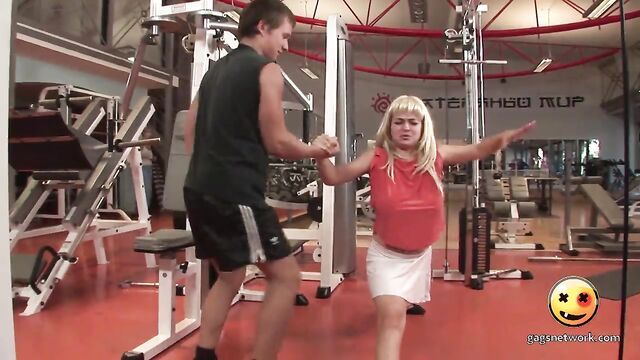A girl with big boobs is having fun in the gym during training