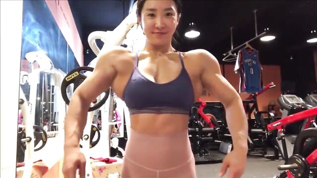 Female Bodybuilder Nikkita Fitness FBB flexes her muscles and shows her strength