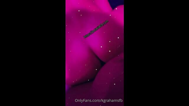 A muscular bodybuilder with fake big boobs is playing around