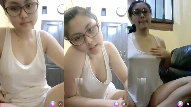 A sexy woman with big boobs shows her beautiful body in satin robes