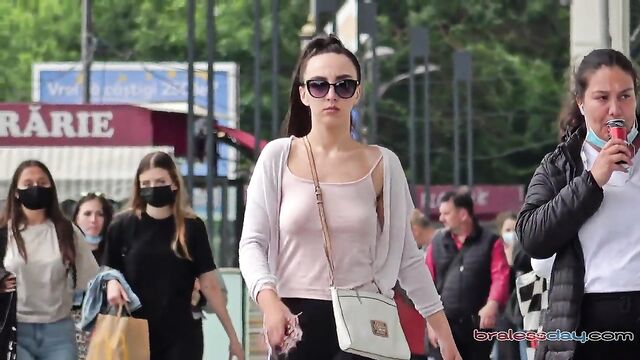 A woman walks the city braless with her underboob exposed