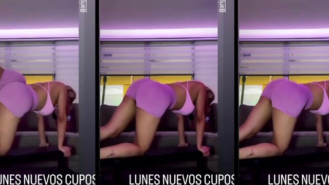 Fitness girl is having fun with her personal trainer in gym