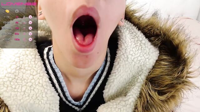 The camgirl shows her tongue and plays with her uvula in a kinky tease