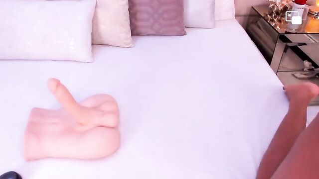 A Latina with a huge ass masturbates using a dildo on cam
