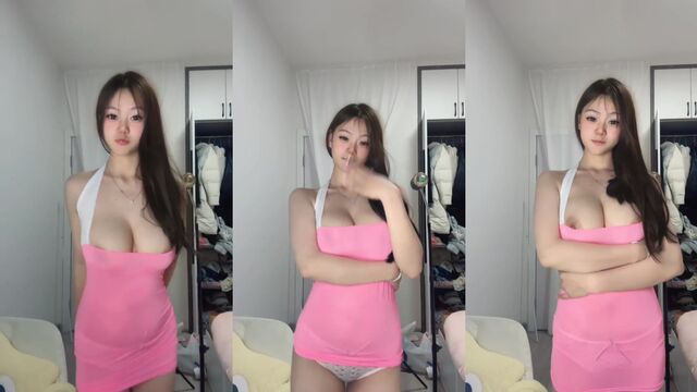 A Chinese girl is dancing sexy on her room, showcasing her allure