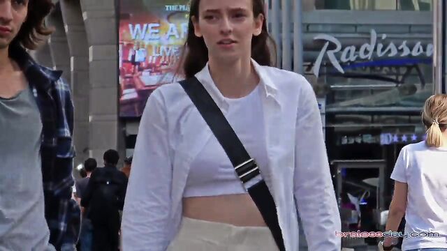Braless woman gets her nips out walking on the street