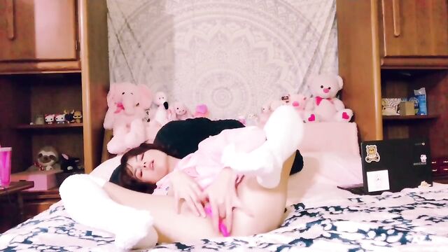 A tiny and gorgeous babe masturbates with a toy until she cums hard