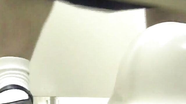 A man pees on the girl while she is wiping her ass in the toilet