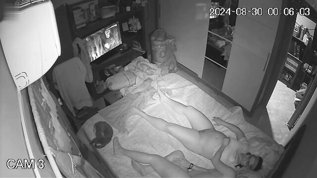 Voyeur spies on lesbians having fun in the bedroom