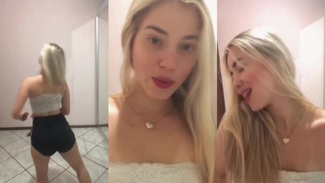 A hot blonde girl shows her ass while dancing on the street