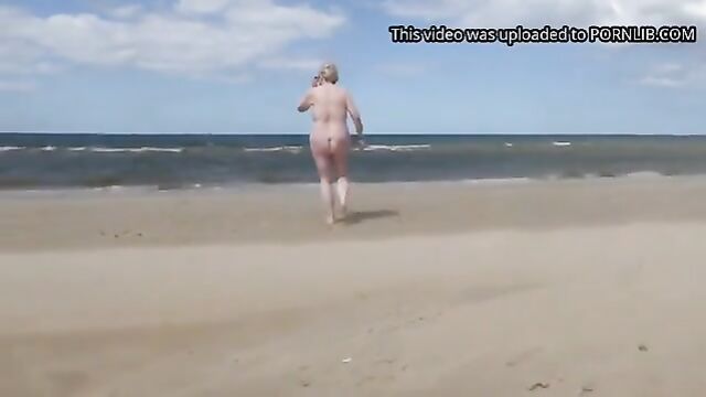 A fat old woman gets exposed on a nude beach
