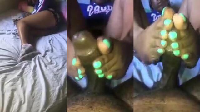 Ebony babe gives a footjob with her huge feet, showcasing intense passion