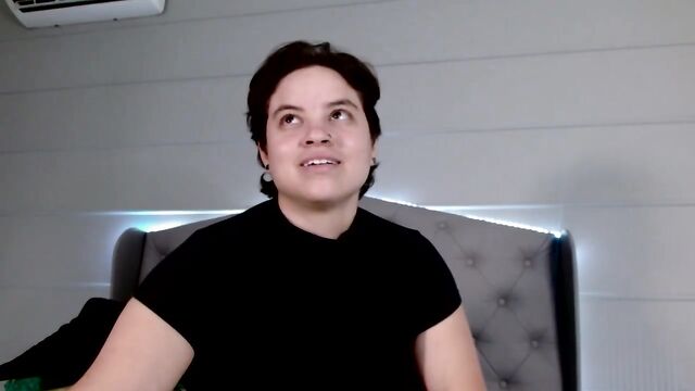 A beautiful FTM individual with short hair enjoys intimate moments in a personal setting