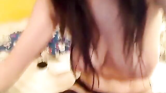Soft and hairy Asian girl plays with her pussy