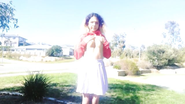 A girl is walking on the street completely naked and masturbating