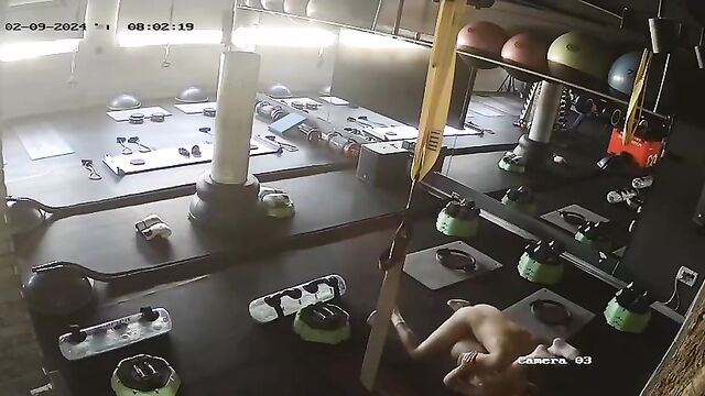 A personal trainer and client get intimate on the gym CCTV