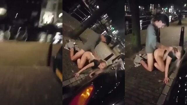 A drunk chick is having fun with a stranger on the street
