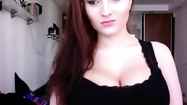 The cam girl with huge boobs plays with them on a vintage camera