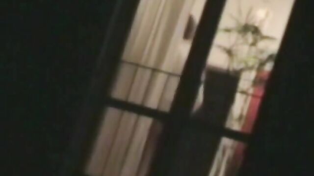 A beautiful girl is being spied on through the window, her nudity exposed