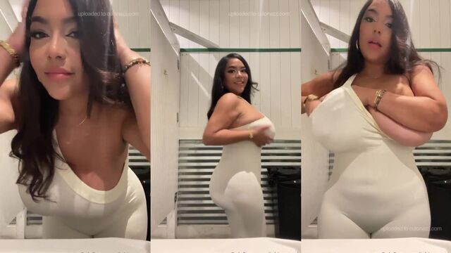 A girl with big tits plays with her boobs in a sensual way