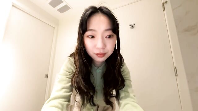 Cute petite Asian girl teasing in the bathtub