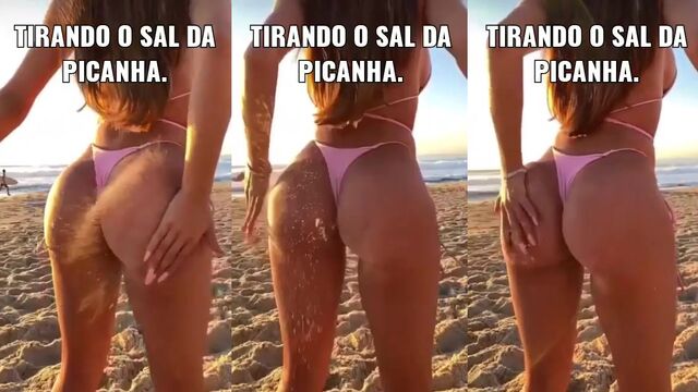 A babe claps her ass on the sandy beach