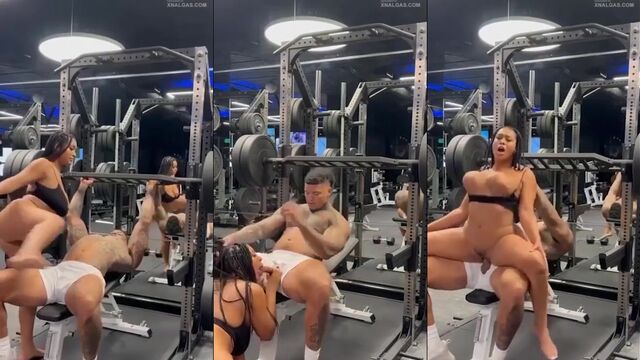 The girl is having fun with the trainer in the gym, interrupting his work