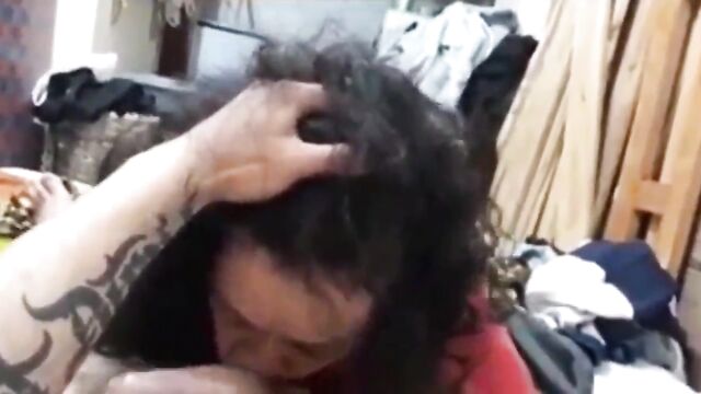 A mature woman with a mustache reaches a screaming orgasm