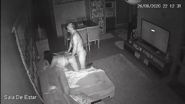 A mature couple is fucking on the couch in the living room