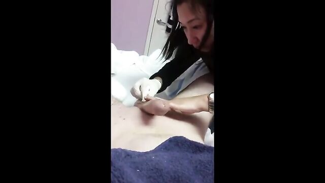 An Asian lady waxes her client’s body and gives him a handjob