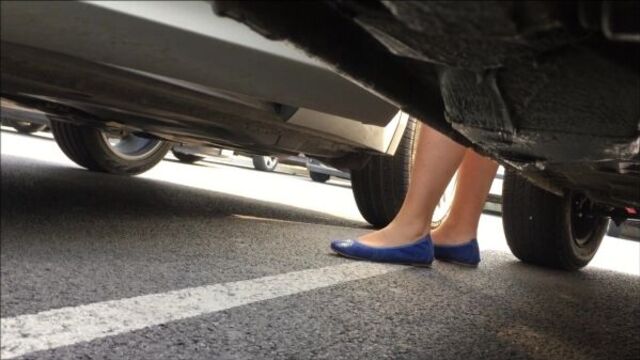 Unknown hand crush by two woman witha new VW Touran
