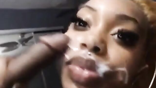 Ebony slut gets her face covered with a messy nut after giving a blowjob