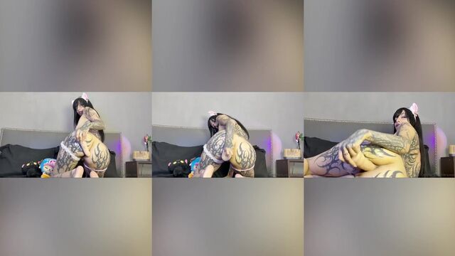 Goth girl fingers her pussy with a big dildo