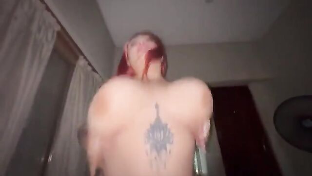 A beautiful tattooed redhead girl rides a dick