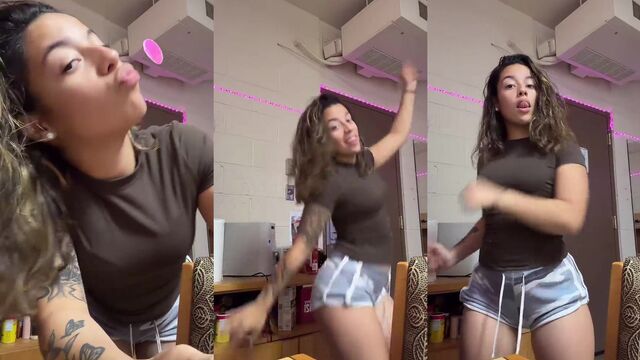 A sexy slim girl in military uniform twerks and shows her long tongue