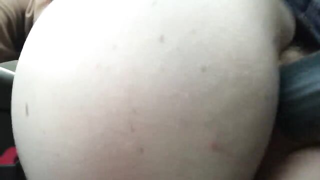 A hot girl masturbates in the car in the parking lot