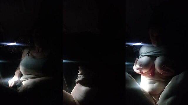 A mature woman playing with a bubble machine in her car and blowing clouds