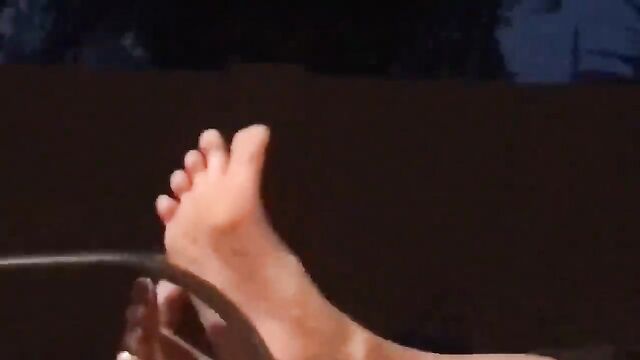 A friend's sister is teasing with her feet, showcasing a stunning display